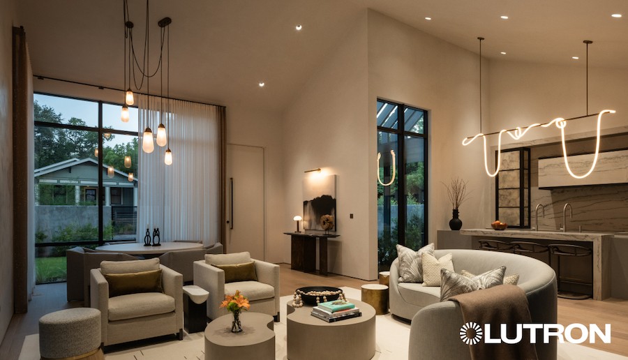 A modern home with an open floor plan and hanging lights.